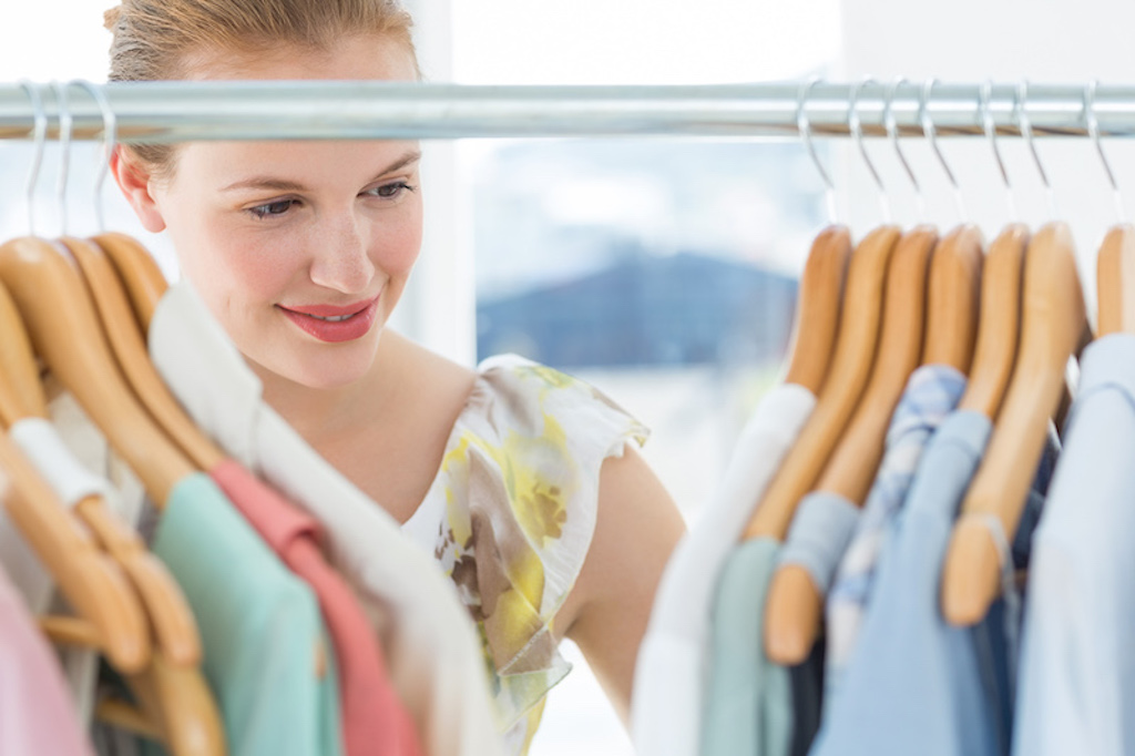 woman at clothing rack pastels