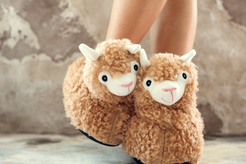 someone wearing fuzzy brown stuffed animal lamb slippers