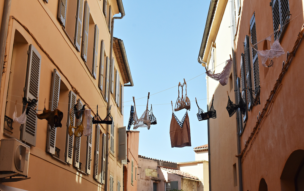 Lingerie hanging on line between French buildings