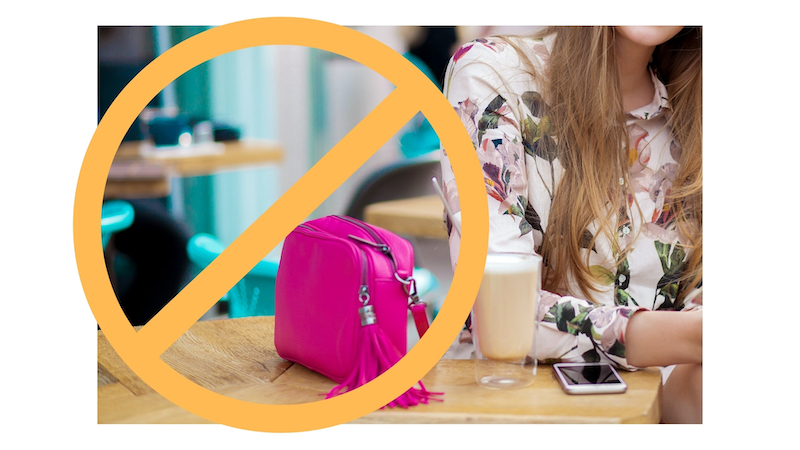 picture of woman's handbag sitting next to her on top of dining table