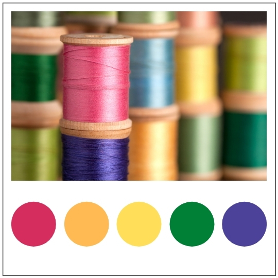 stacks of different color spools of thread