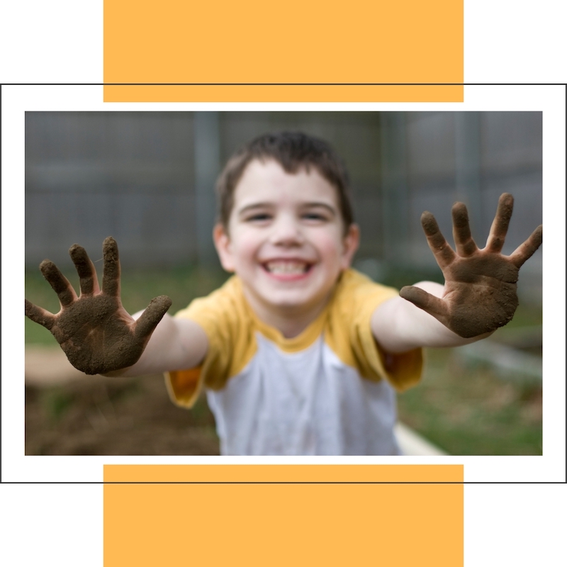 little boy with muddy hands reaching for hug