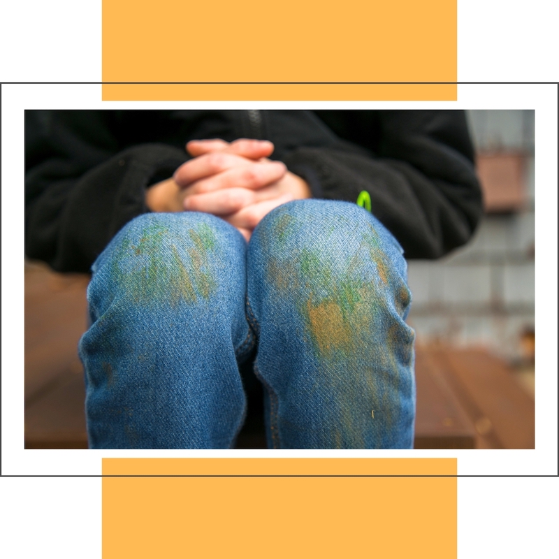 grass stains on kid's jeans at knees