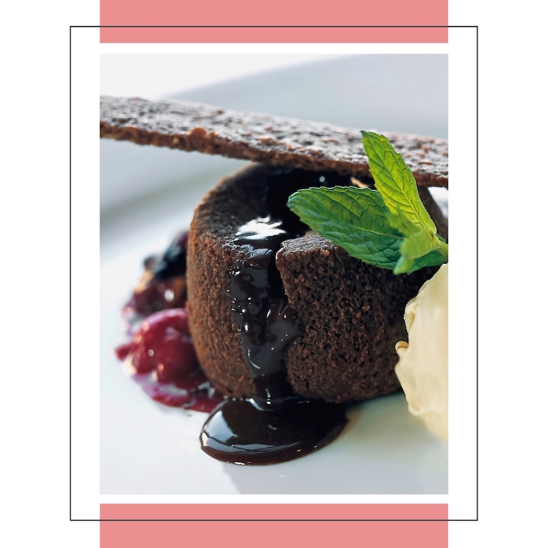 chocolate souffle with sauce oozing out onto plate