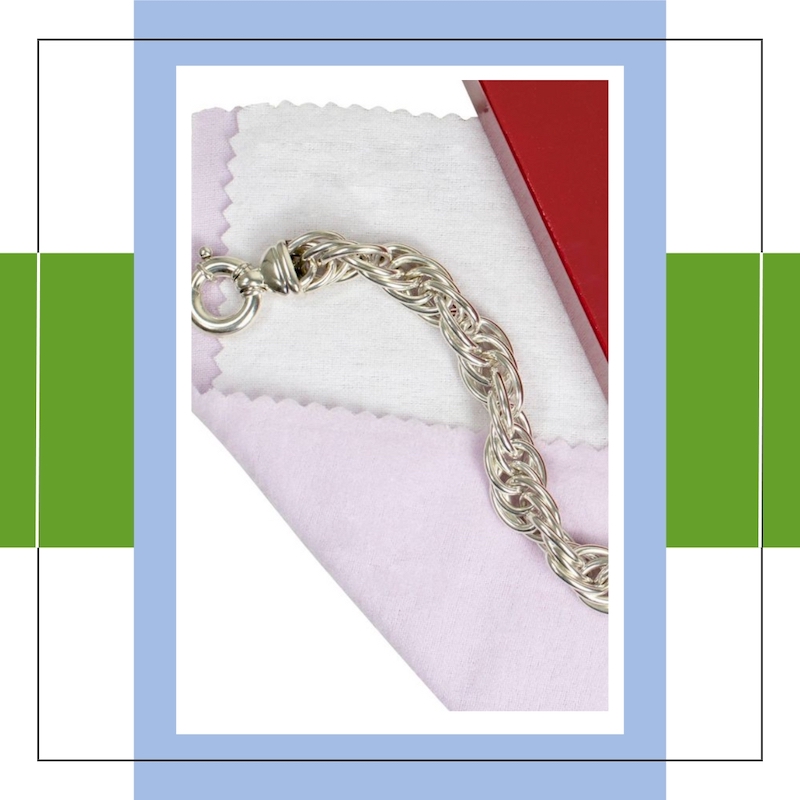 silver bracelet on top of silver cleaning cloth