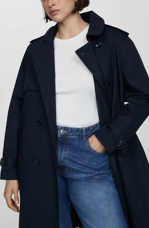 woman in navy trench coat with white t-shirt and jeans