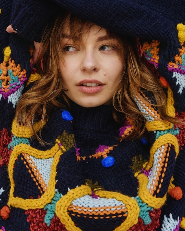 woman wearing colorful, bold statement sweater